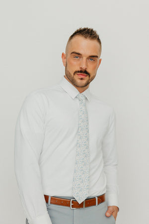 Bluebell tie worn with a white shirt, brown belt and gray pants.