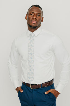 Bluebell tie worn with a white shirt, brown belt and blue pants.