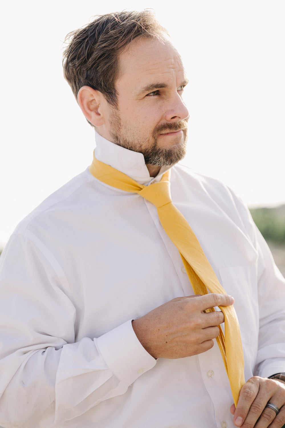 Golden tie worn with a white shirt.