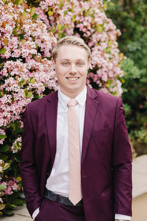 Pale Pink Tie worn with a white shirt and plum purple suit.
