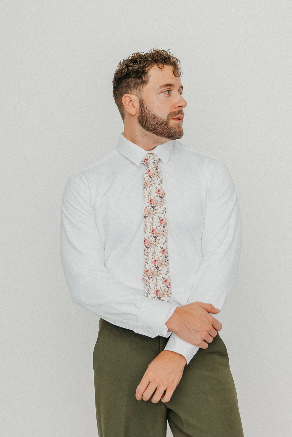 Quicksand Roses tie worn with a white shirt, brown belt and olive green pants.