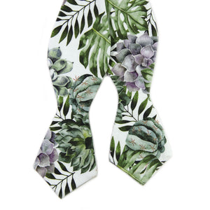 Aloe Self Tie Bow Tie. White background with big green succulents and leaves, and also purple succulents.