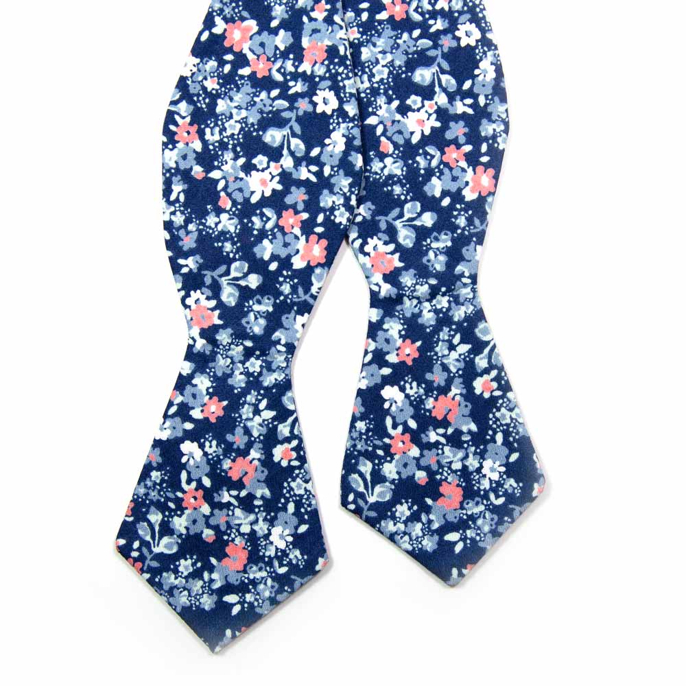 Atlanta Self Tie Bow Tie. Navy background with small dusty blue, white, and blush pink flowers.