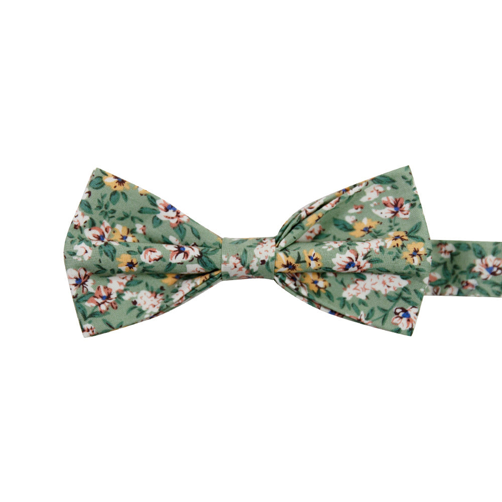 Faded Jade Pre-Tied Bow Tie. Sage background with white, blush and yellow flowers with blue flower centers, dark sage leaves.