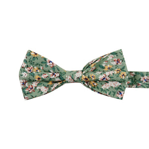 Faded Jade Pre-Tied Bow Tie. Sage background with white, blush and yellow flowers with blue flower centers, dark sage leaves.