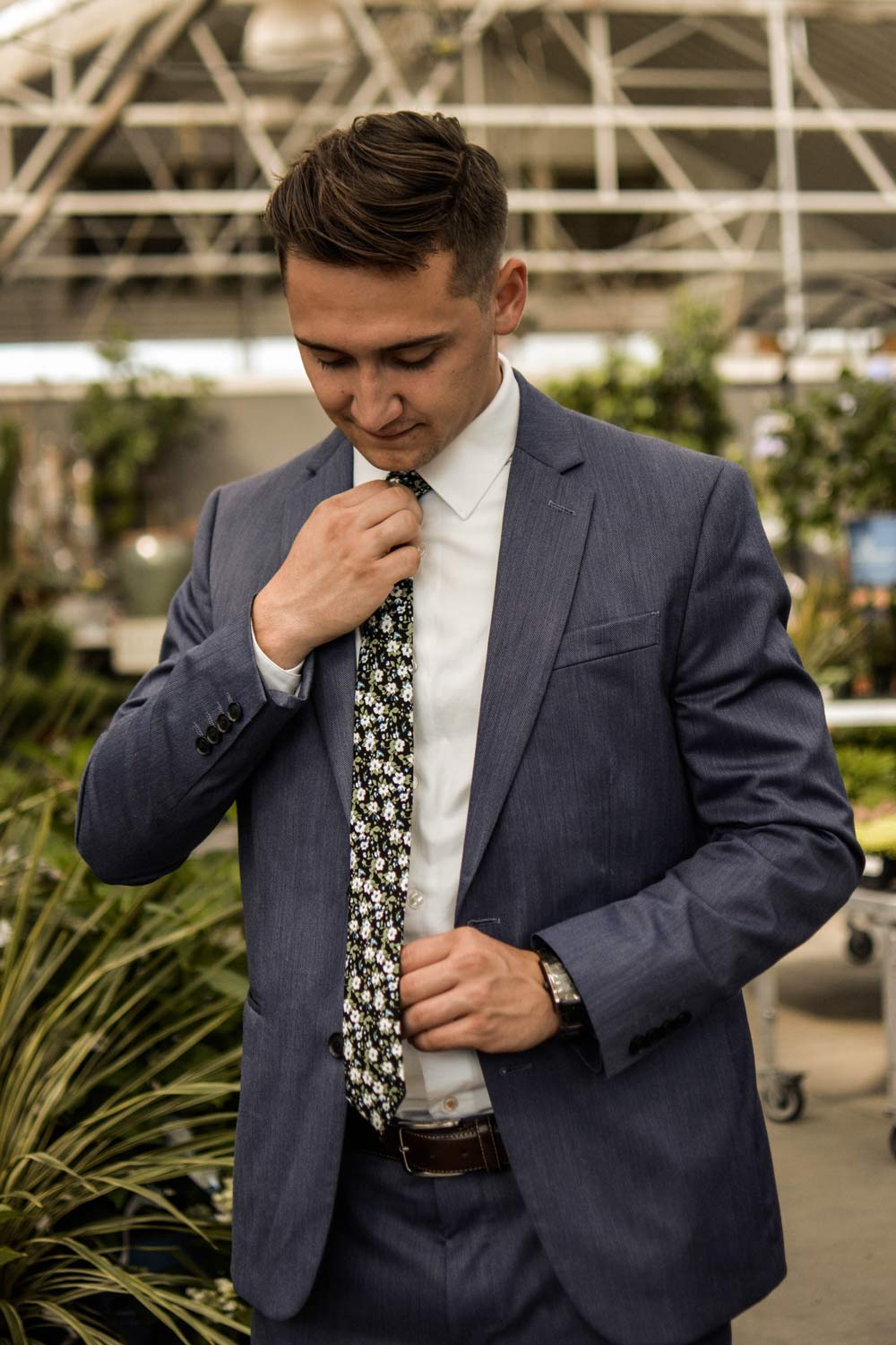 Morning Glory tie worn with white shirt, brown belt and dark navy blue suit.