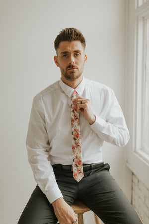 Peony tie worn with a white shirt, black belt and black pants.