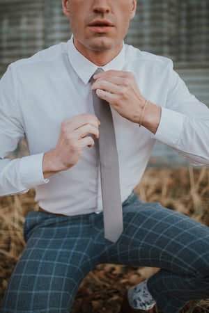 Portobello tie worn with a white shirt and blue checkered pants.