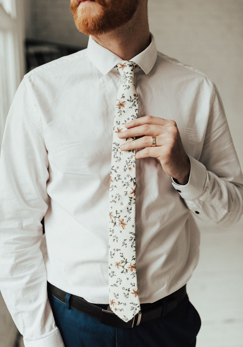 Sugar Blossom tie worn with a white shirt, dark brown belt and navy pants.