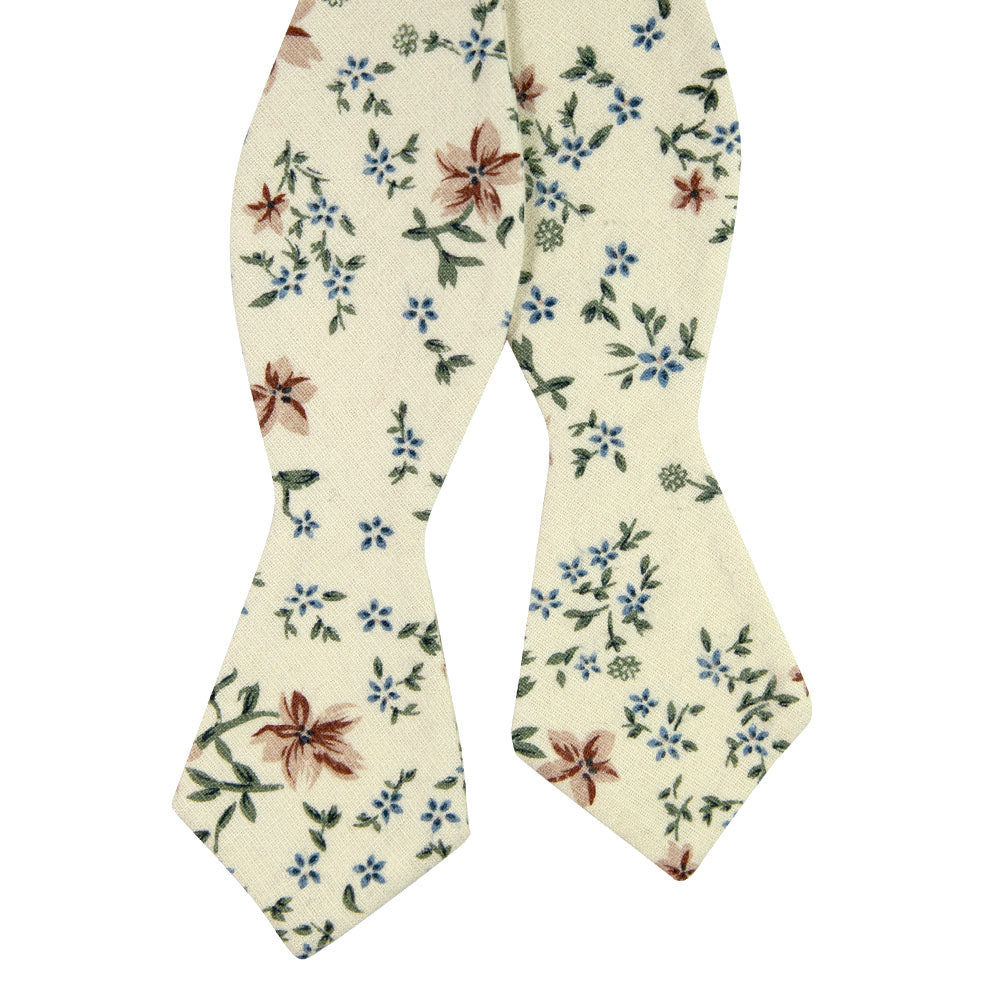 Sugar Blossom Self Tie Bow Tie. Cream background with medium size mauve flowers, small dusty blue flowers, and sage green leaves.