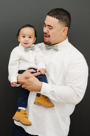 Sunny Meadow pre-tied bow tie worn by a father and son with a white shirt and blue pants.