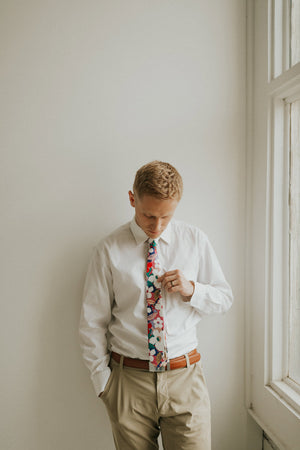 Surfs Up tie worn with a white shirt, brown belt and khaki pants.
