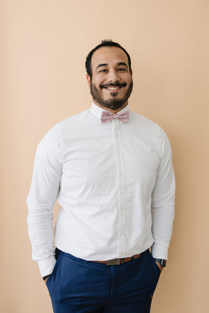 Ventura pre-tied bow tie worn with a white long sleeve shirt and blue pants.