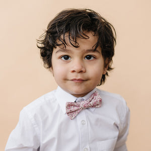 Ventura pre-tied bow tie worn with a white long sleeve shirt.