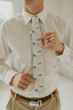 Wild Flower tie worn with a white shirt, brown belt and khaki pants.