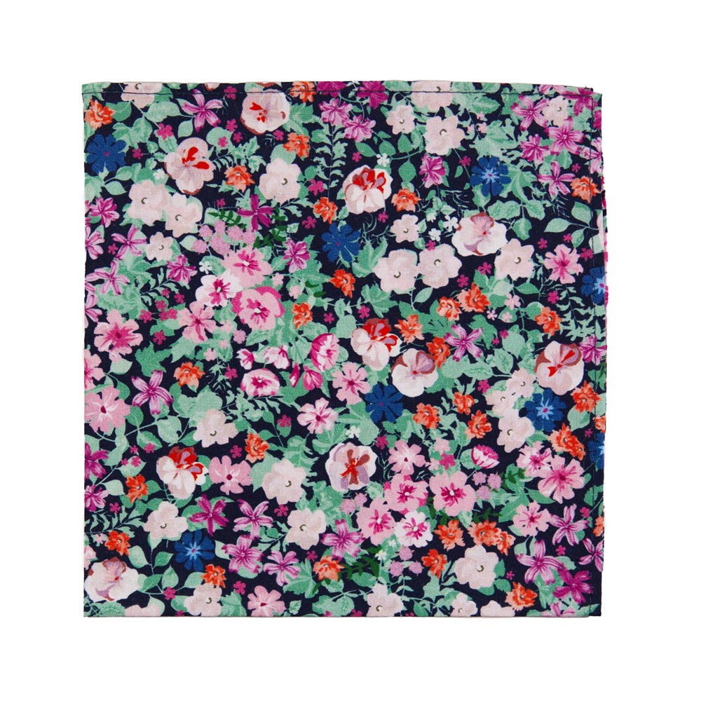 Abyss Pocket Square. Dark navy blue background with a mix of pink, blue and orange flowers and green leaves.