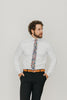 Abyss 2.5" Wide Skinny Tie worn with a white shirt, brown belt and black suit pants.