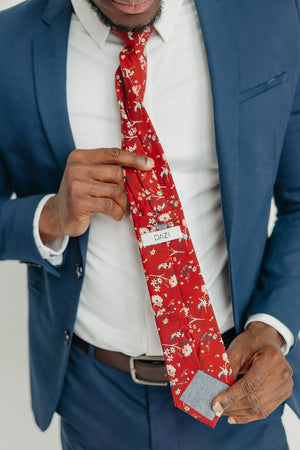Autumn tie worn with a white shirt, brown belt and blue suit.