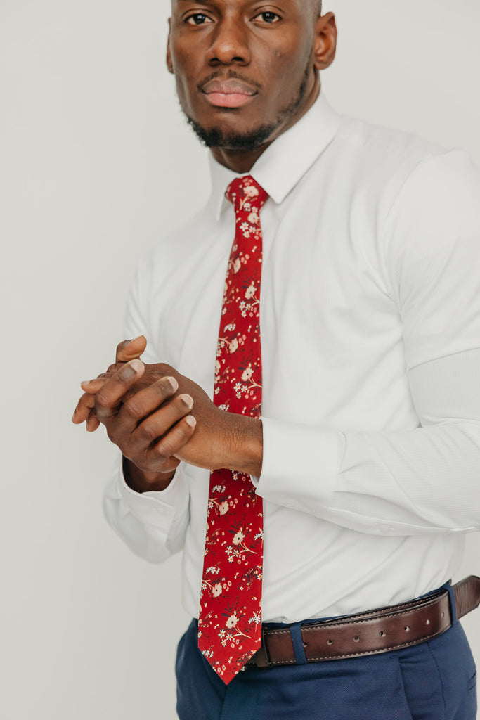 Autumn tie worn with a white shirt, brown belt and blue pants.