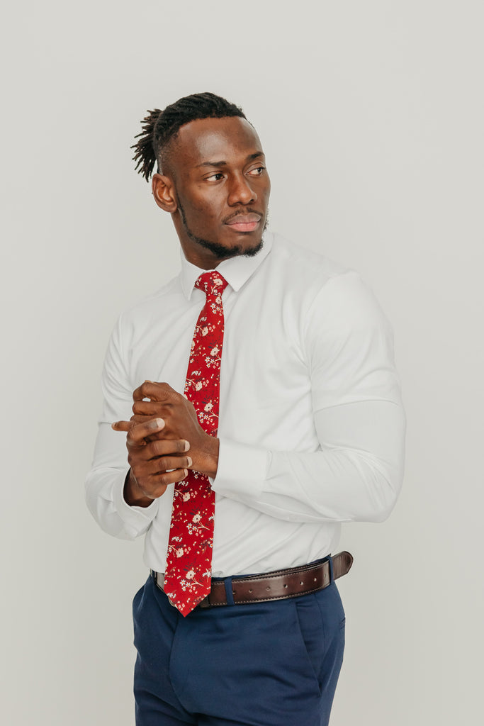 Autumn tie worn with a white shirt, brown belt and blue pants.