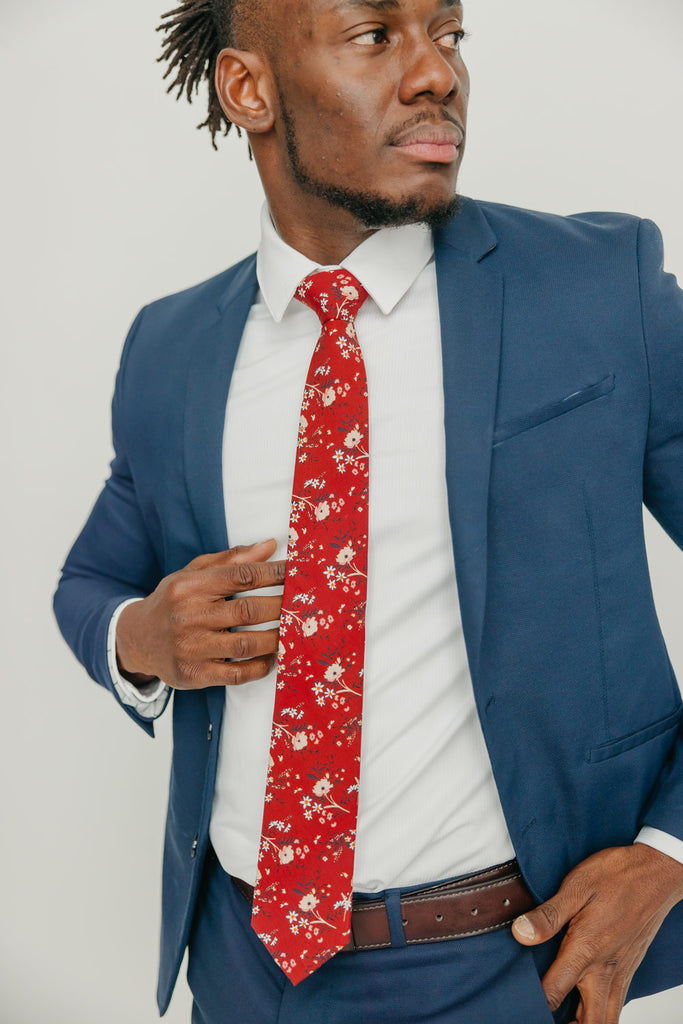 Autumn tie worn with a white shirt, brown belt and blue suit.