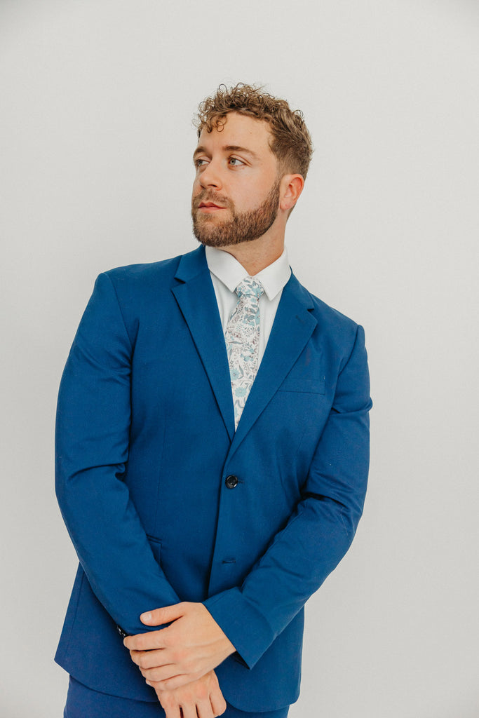 Baltic tie worn with a white shirt and blue suit.