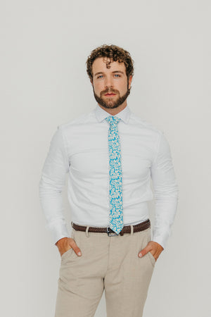 Blue Daisy 2.5" Wide Skinny Tie worn with a white shirt, brown belt and tan suit pants.