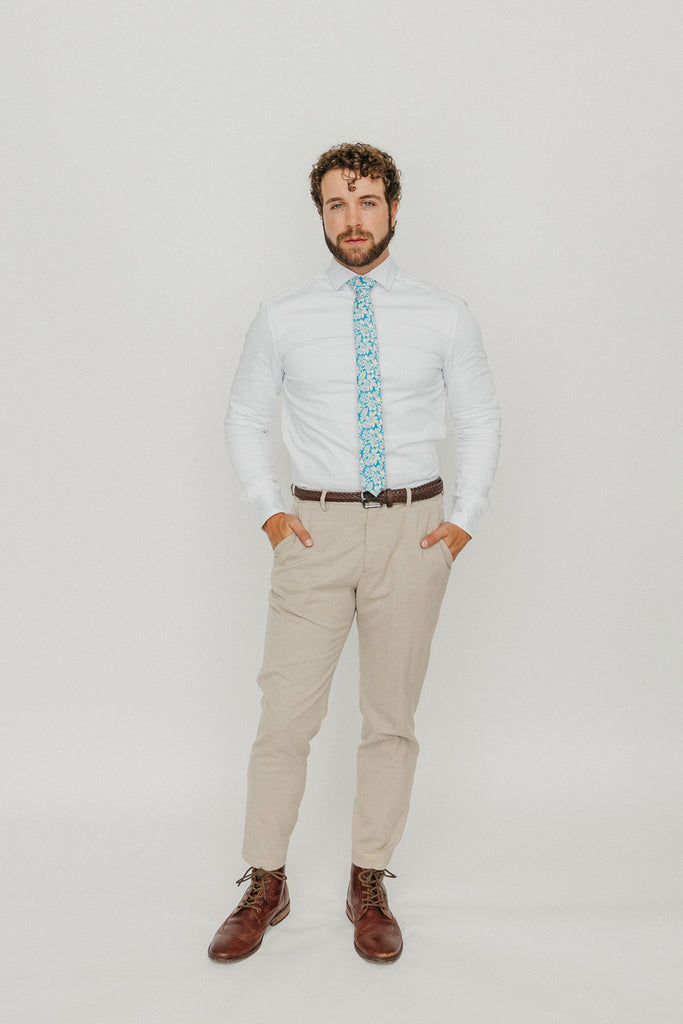 Blue Daisy 2.5" Wide Skinny Tie worn with a white shirt, brown belt and tan suit pants.