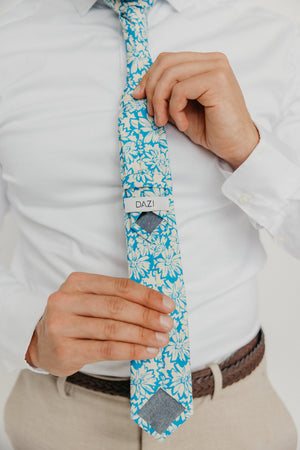 Blue Daisy 2.5" Wide Skinny Tie worn with a white shirt, brown belt and tan suit pants.
