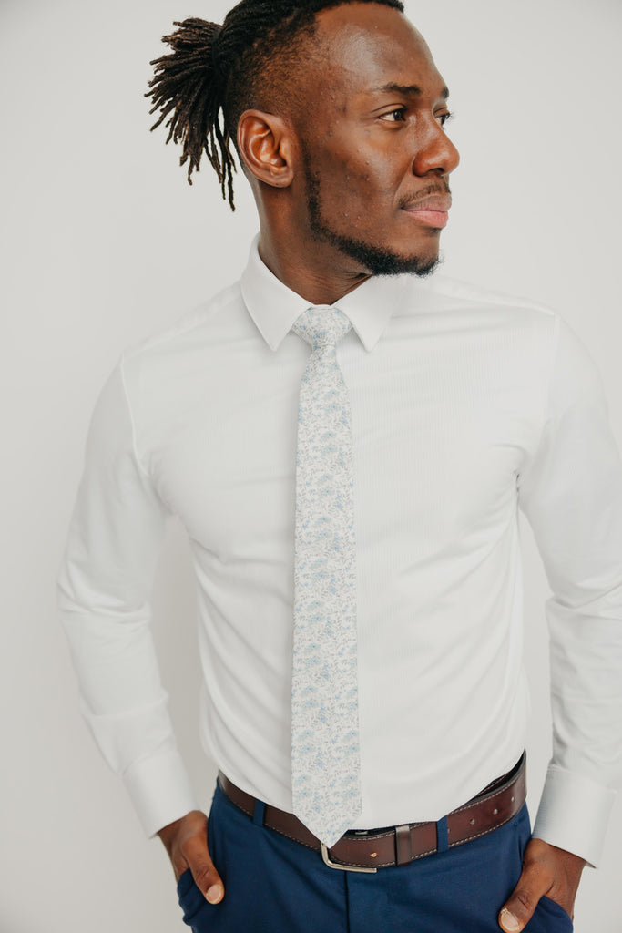 Bluebell tie worn with a white shirt, brown belt and blue pants.