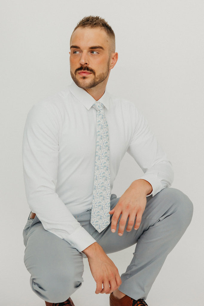 Bluebell tie worn with a white shirt, brown belt and gray pants.