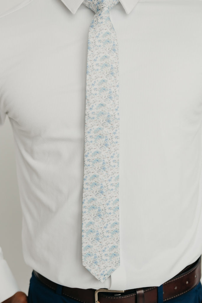 Bluebell tie worn with a white shirt, brown belt and blue pants.