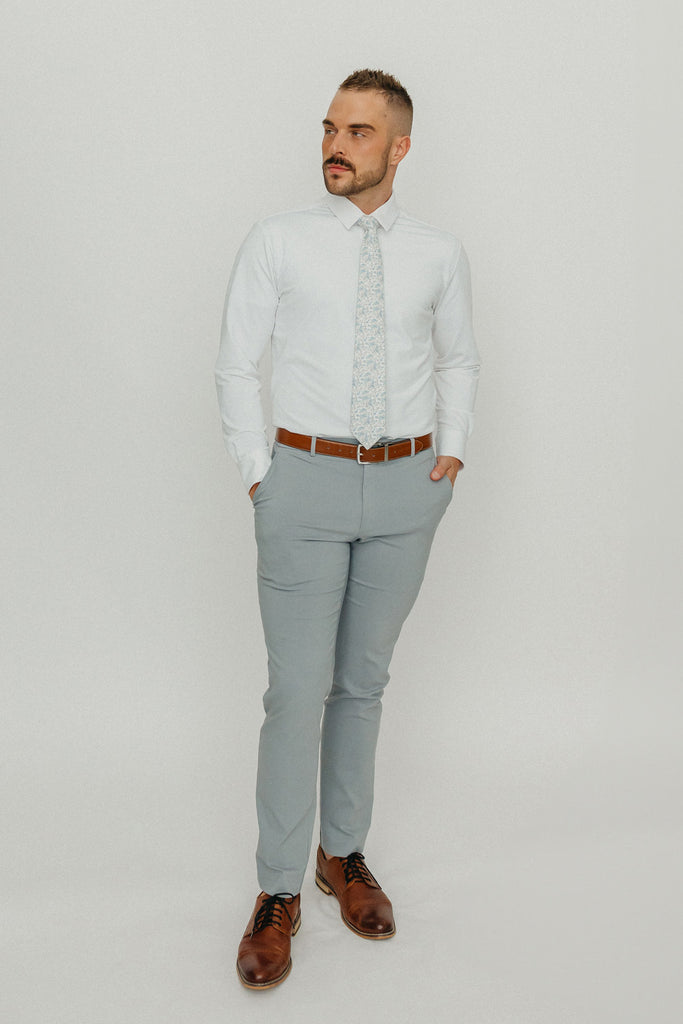 Bluebell tie worn with a white shirt, brown belt and gray pants.