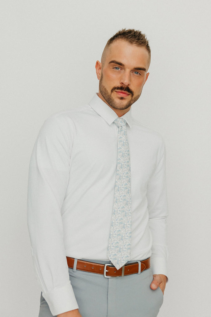 Bluebell tie worn with a white shirt, brown belt and gray pants.