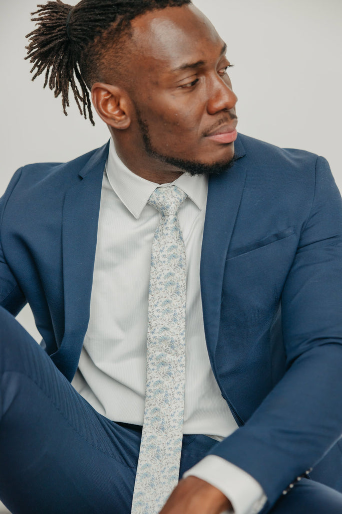 Bluebell tie worn with a white shirt, brown belt and blue suit.