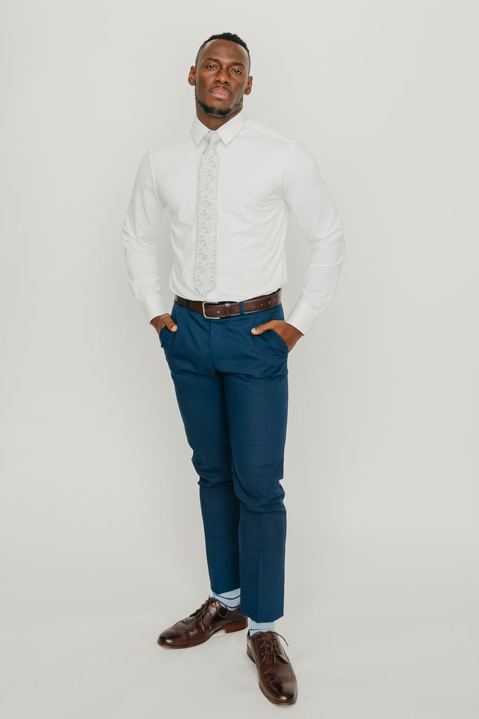 Bluebell tie worn with a white shirt, brown belt and blue pants.