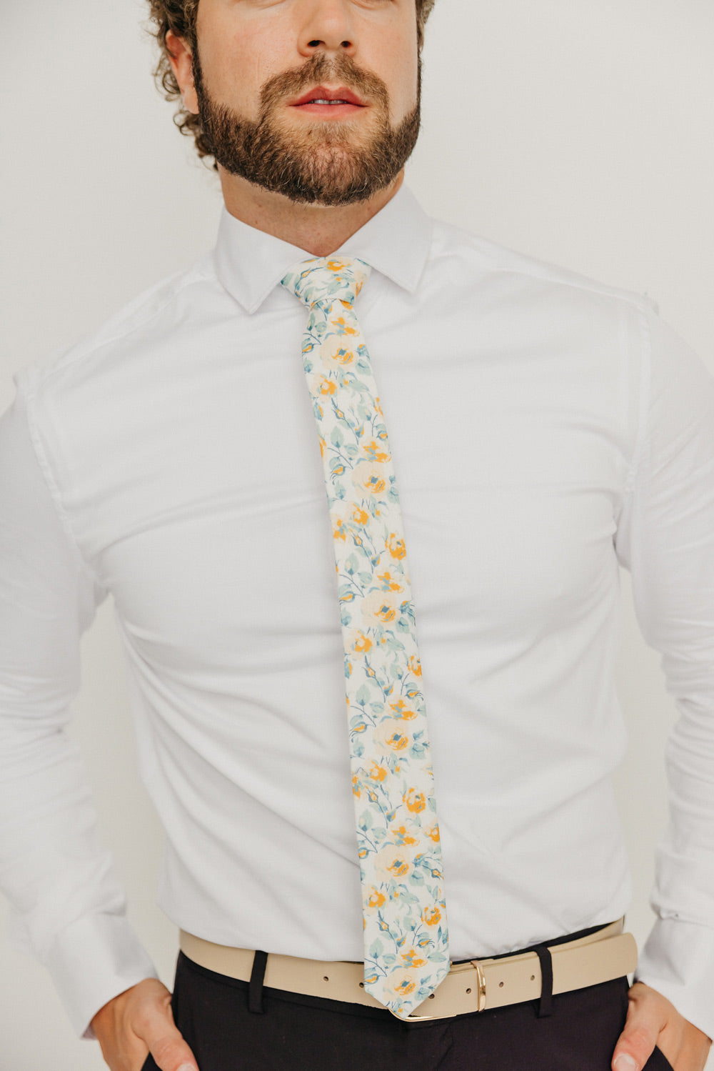 Butterscotch 2.5" Wide Skinny Tie worn with a white shirt, tan belt and black suit pants.