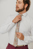 Carnation 2.5" Wide Skinny Tie worn with a white shirt, tan belt and maroon suit pants.