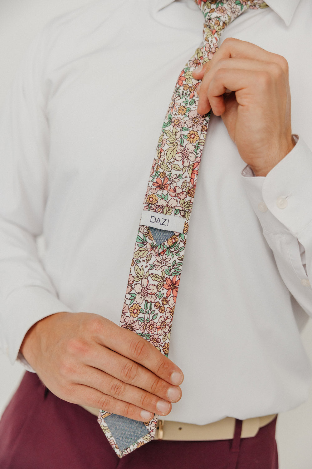 Carnation 2.5" Wide Skinny Tie worn with a white shirt, tan belt and maroon suit pants.