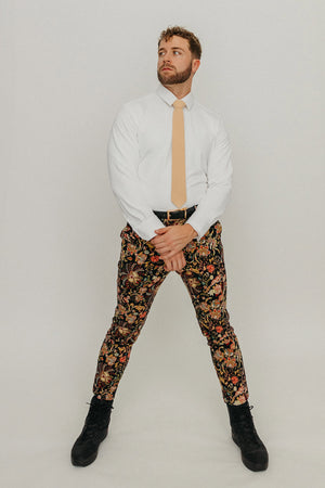 Champagne tie worn with a white shirt, black belt and floral pants.