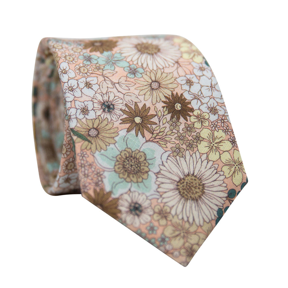 DAZI Country Sun Tie. Light Pink background with a variety of sunflowers and other flowers. 
