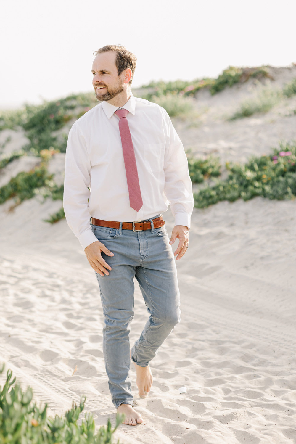 Dusty Rose Tie worn with a white shirt and blue pants.