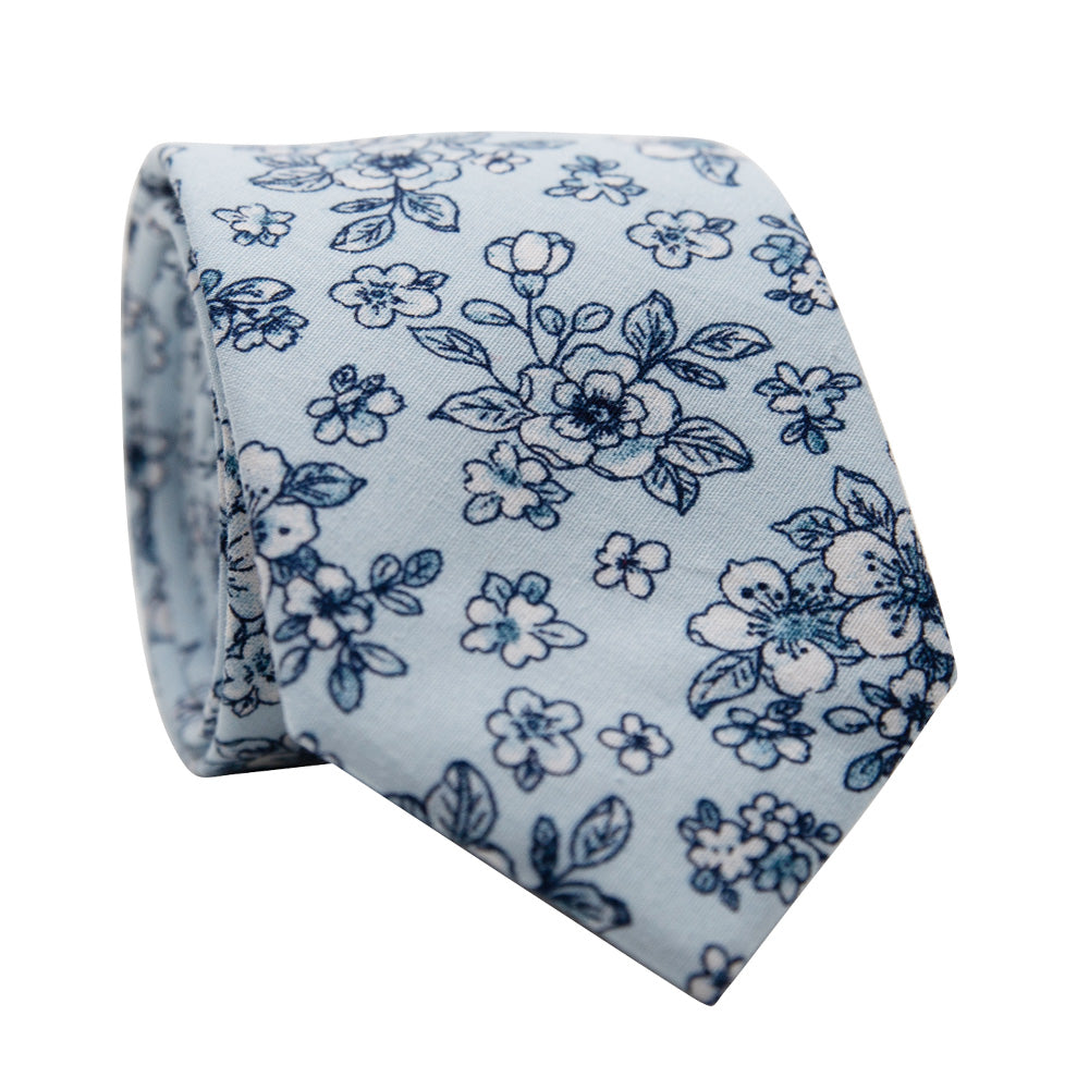 Frost Skinny Tie. Light blue background ith small navy blue and white flowers and leaves. 