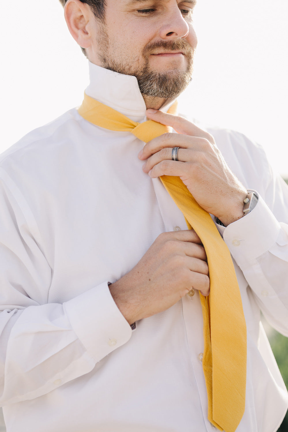 Golden tie worn with a white shirt. 
