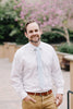 Ice Blue tie worn with a white shirt and tan pants.