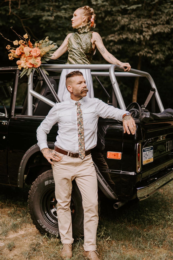 Jumanji Tie worn with a white shirt and tan pants.