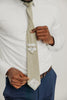 Light Sage tie worn with a white shirt, brown belt and blue pants.