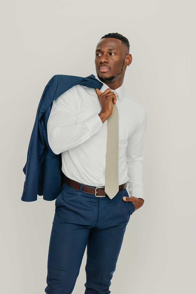 Light Sage tie worn with a white shirt, brown belt and blue pants.
