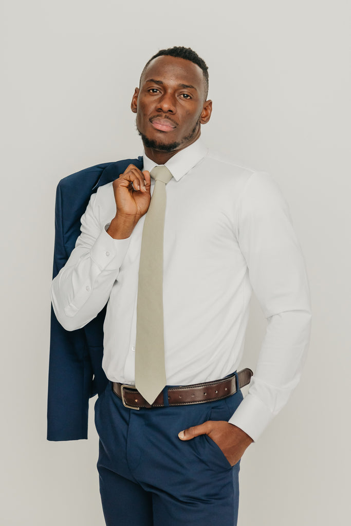 Light Sage tie worn with a white shirt, brown belt and blue pants.