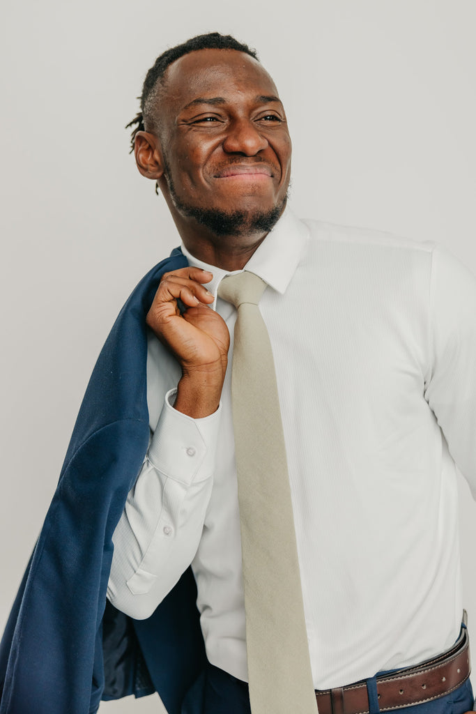 Light Sage tie worn with a white shirt, brown belt and blue pants.